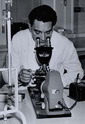 Photograph of student looking through a microscope