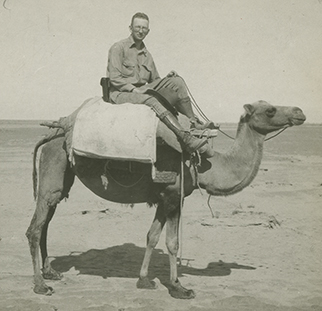 Photograph of George Cressey riding a camel