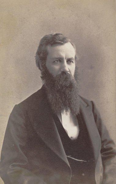 Portrait of Chancellor Winchell, a person in a dark suit and long beard.