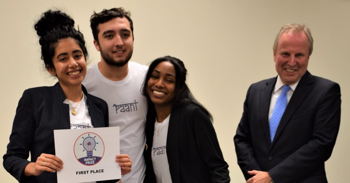 Winning student team of three pose for a photo with David Seaman, Dean of SU Libraries