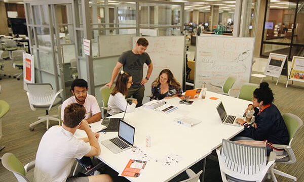 students gathered around a table working