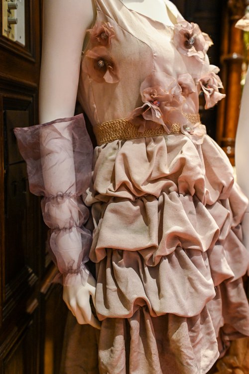 closeup of beige dress with flowers and layers