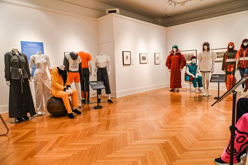 fashions on mannequins in room with wood floor