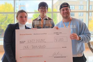 Prize winner Katy Arons with event organizer Andrew Kim and competition emcee Selim Dangoor