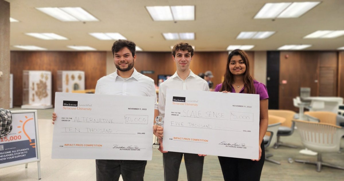 Ethan Tyo holding $10,000 oversized check on the left, Oliver Raycroft and Adya Parida holding $5,000 oversized check on the right