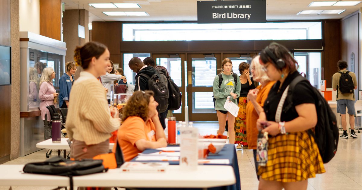 people standing on both sides of table at Bird Library