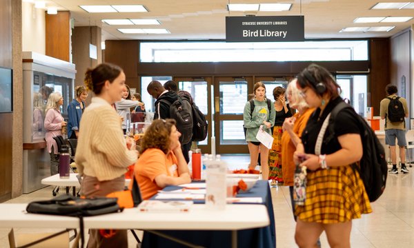 people standing on both sides of table at Bird Library