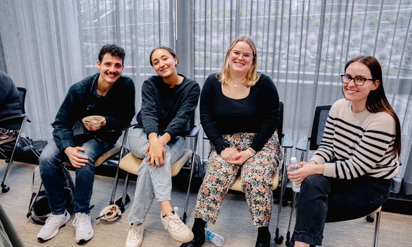 4 people sitting in row