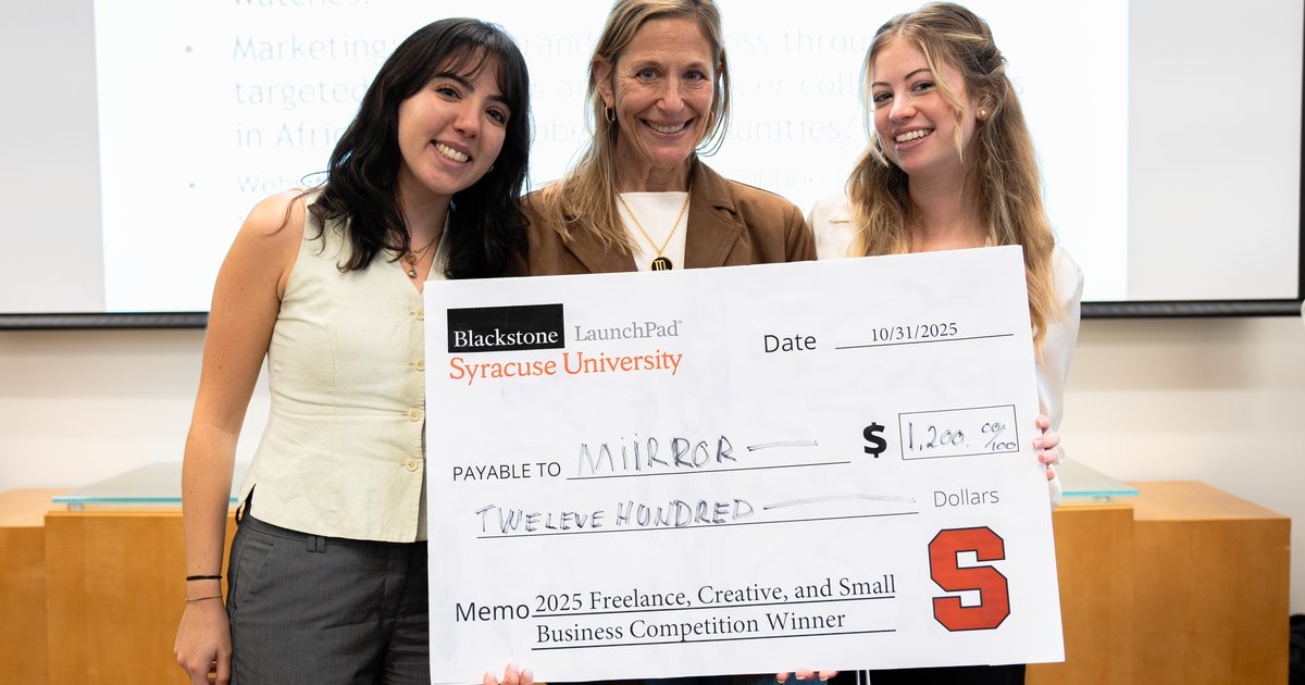 3 people holding oversized check