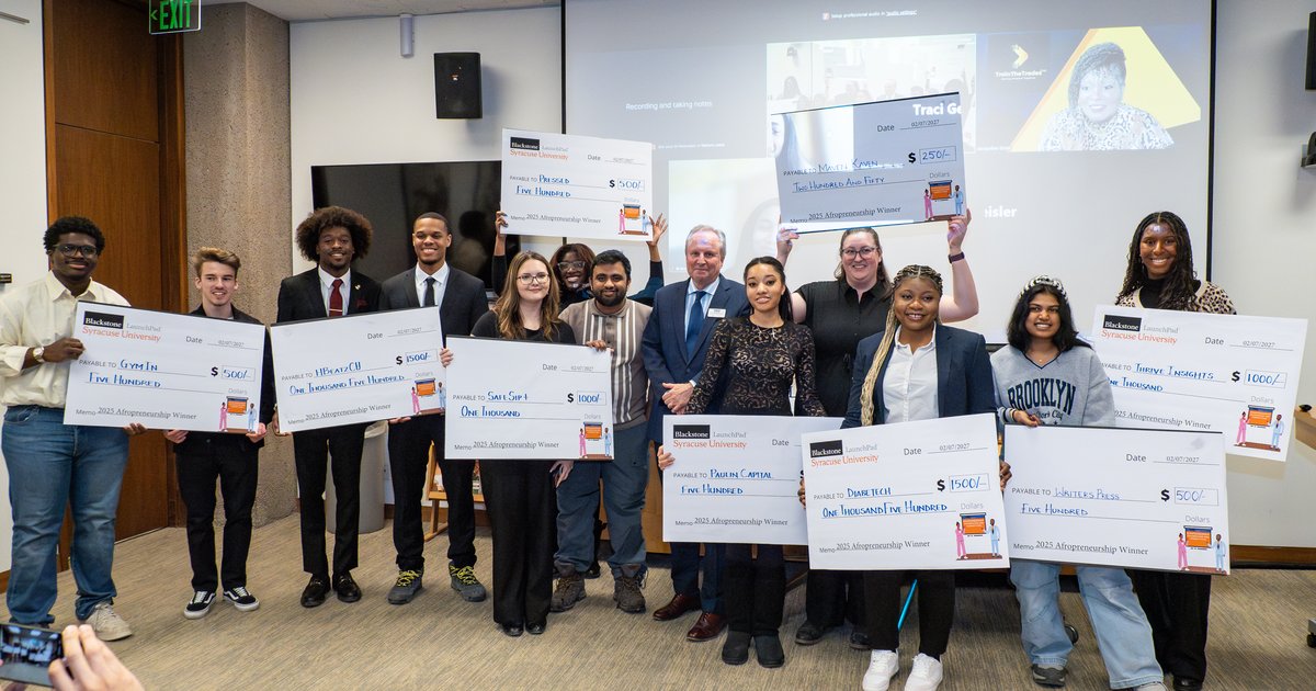 group of people with several holding large oversized checks