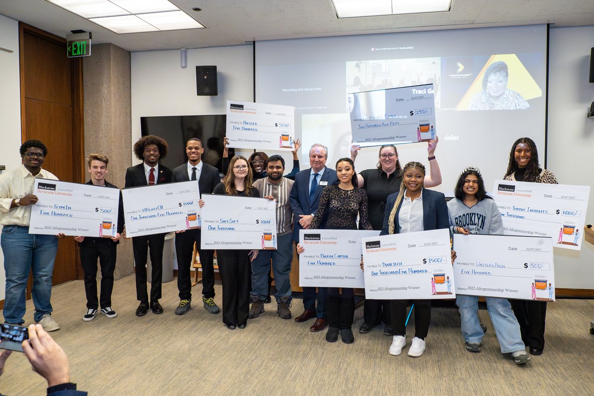 people standing with giant checks