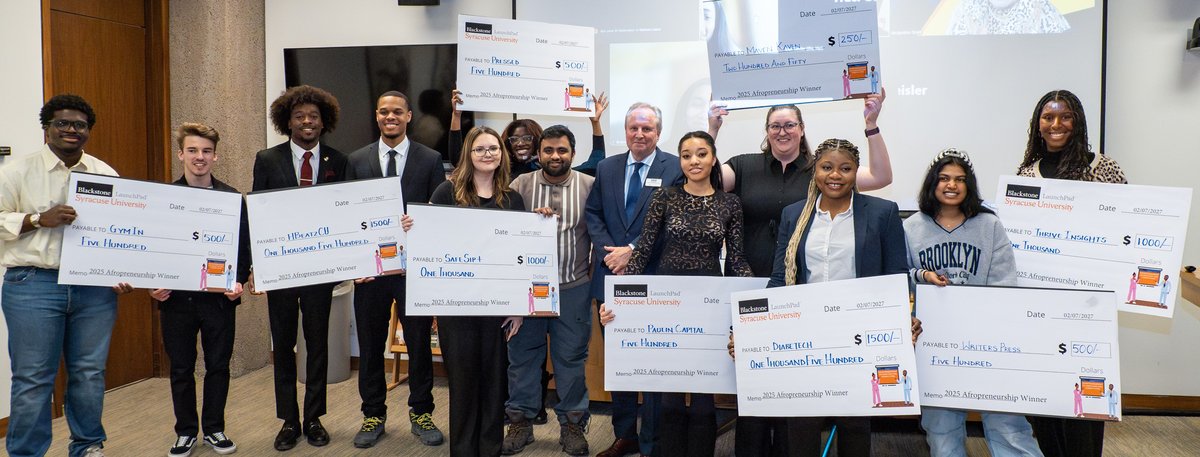 people standing with giant checks