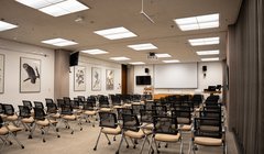 Chairs in rows facing front of room, window on right side of the room.