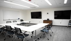 entrance to large room with sign that says "Welcome to Faculty Commons"