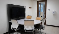 empty room with table, chair and large screen monitor