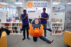 Hult Prize winning team Agbor Edouard Ransom (left) and Souleymane Bah (right) with their winning check and Otto
