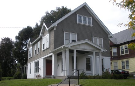 two story house with first floor white siding and second floor beige siding