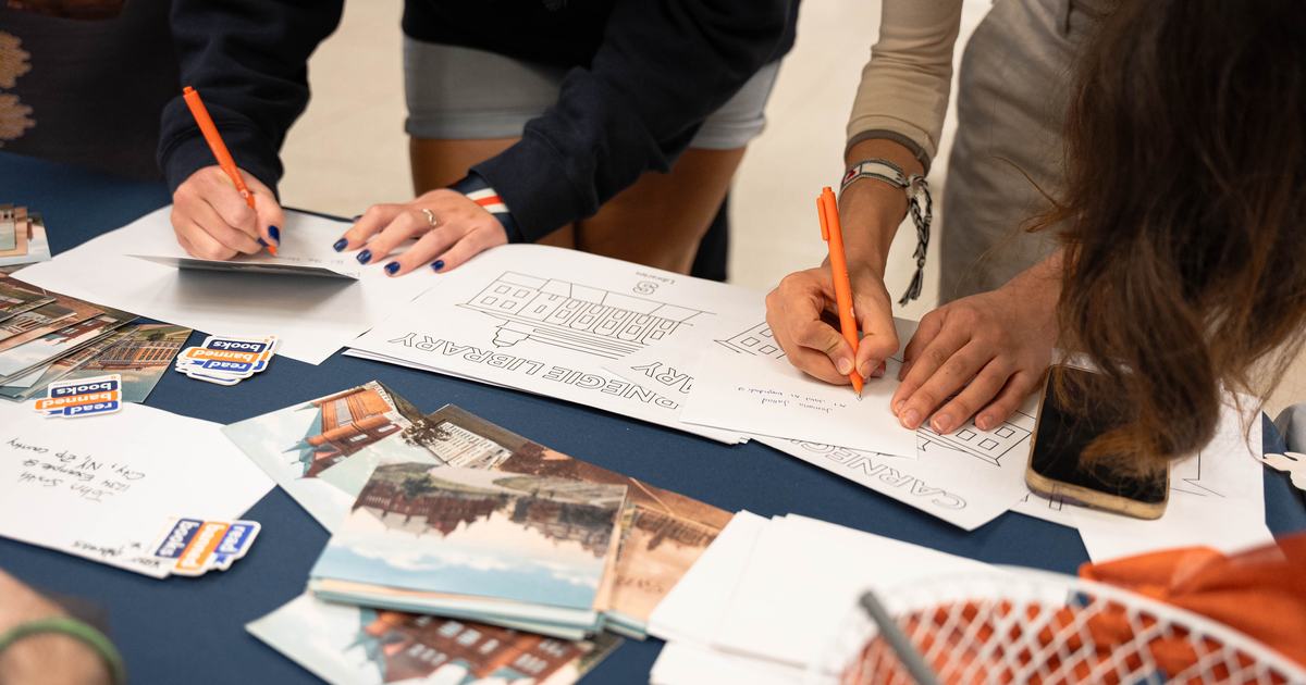 hands writing notes on table