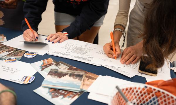 hands writing notes on table