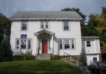 two story white colonial with red door