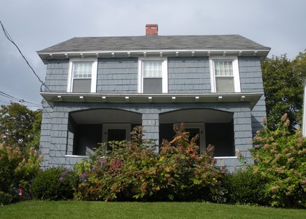 two floor gray colonial with partially covered porch