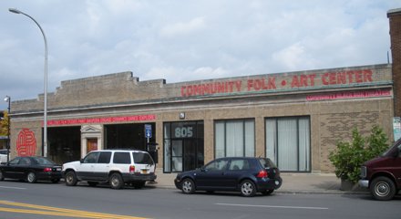 flat concrete storefront with words "Community Folk Art Center" written in red at top of building
