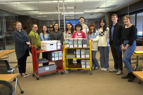 students standing in SCRC with boxes