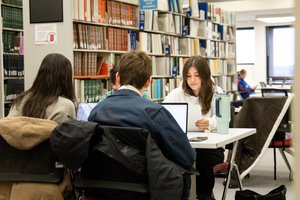 students studying in Bird Library book stacks