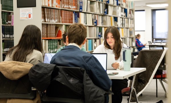 students studying in Bird Library book stacks