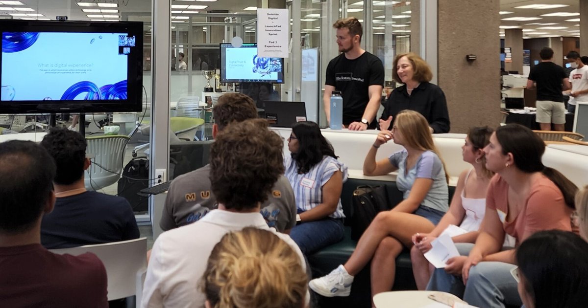 A group of students gather at the Blackstone LaunchPad office, looking at a presentation