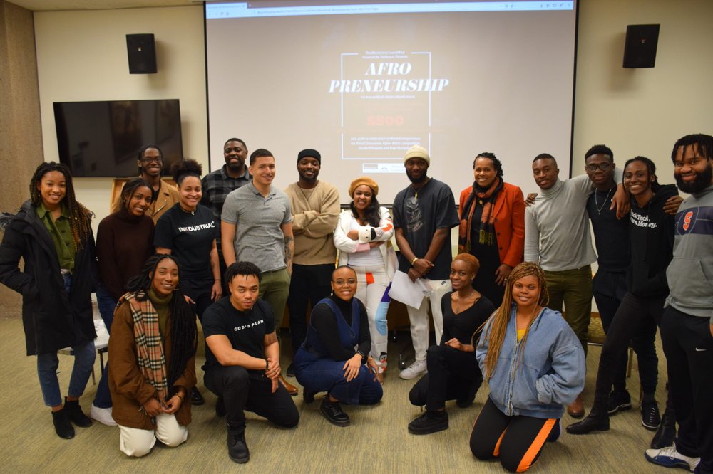 a group of people pose for a group photo
