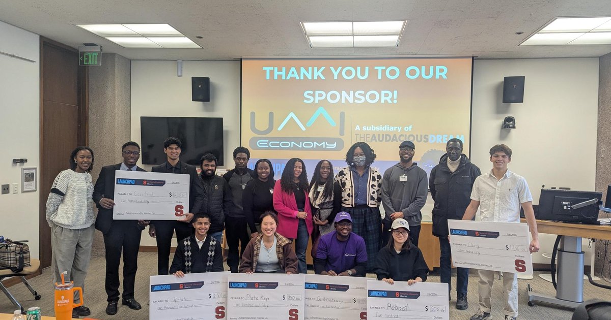 numerous students holding oversized checks