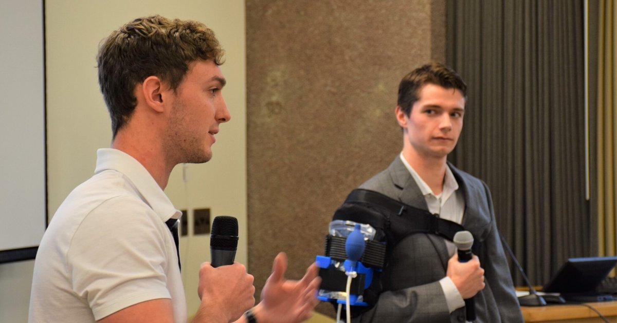 two students pitching