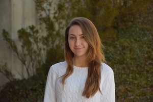 woman in white sweatshirt smiling