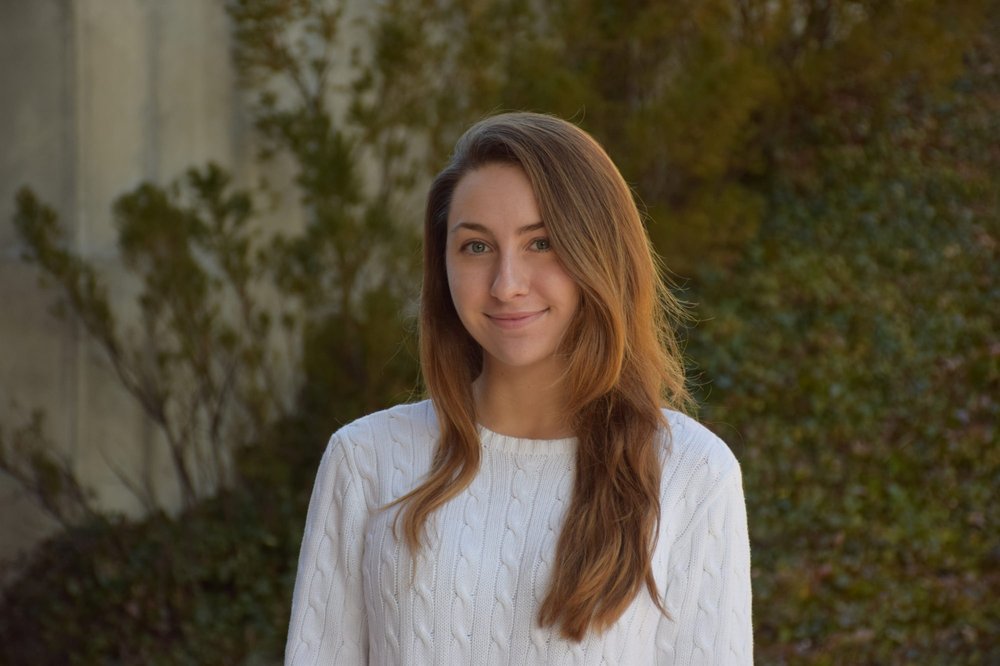 woman in white sweatshirt smiling