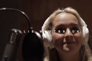 a woman in headphone singing