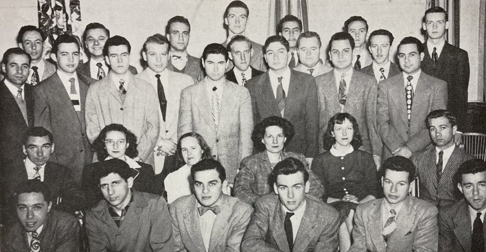 Black and white group photograph showing 30 students arranged into 4 rows. All the students are men, apart from four women seated in the center of the second row.