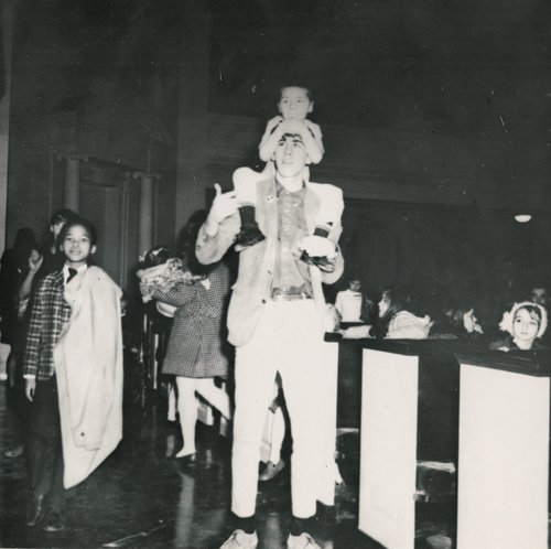 Alpha Phi Omega members playing with children at an event in Hendricks Chapel, circa 1950s.