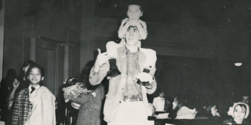 Alpha Phi Omega members playing with children at an event in Hendricks Chapel, circa 1950s.