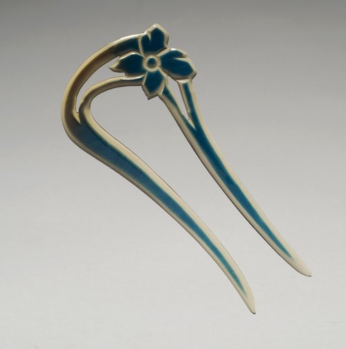 An example of a celluloid hairpin that largely fell out of style the 1920s and 1930s when short hairstyles for women became fashionable.