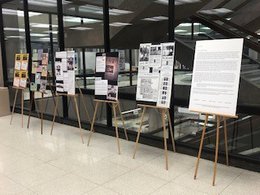 posters hung on walls on first floor of Bird Library