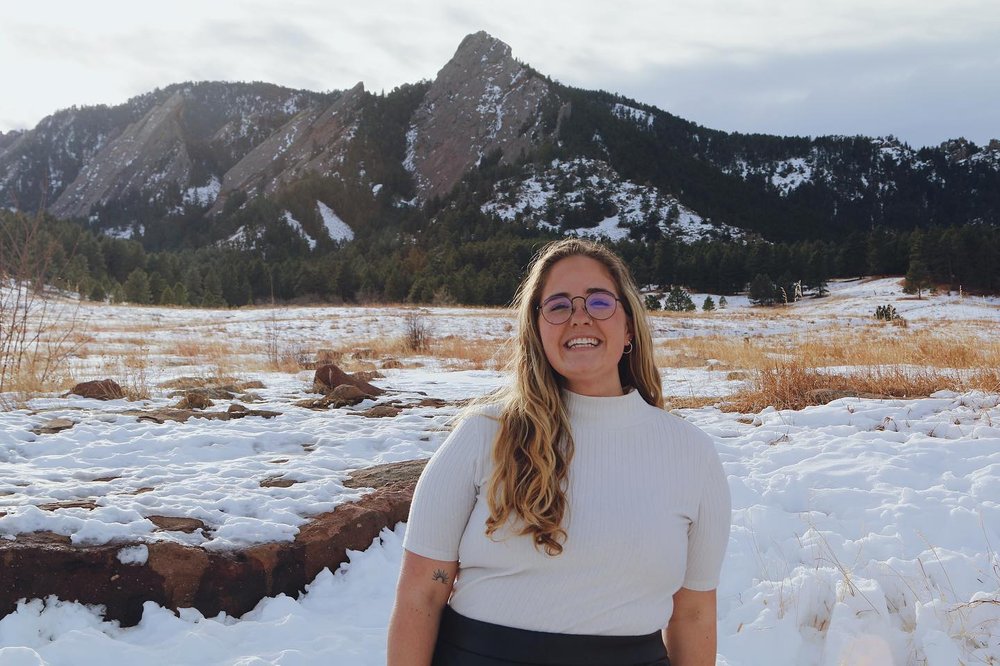 woman standing in field covered in snow