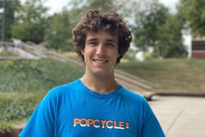 student in a blue POPCYCLE brand shirt