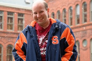 Student in a SU jacket smiling