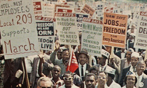 large crowd protesting with signs in hand