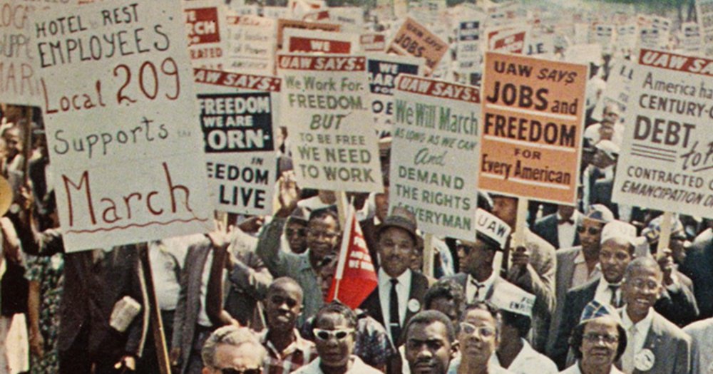 large crowd protesting with signs in hand