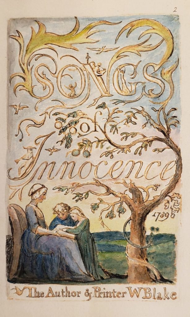 A woman is seated on a chair with two young people leaning over a book held in her lap, while whimsical tree branches curl and twist up from the right of the page forming the title, “Songs of Innocence."