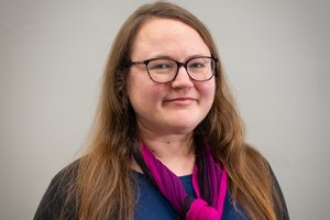 headshot woman wearing glasses with long light brown hair