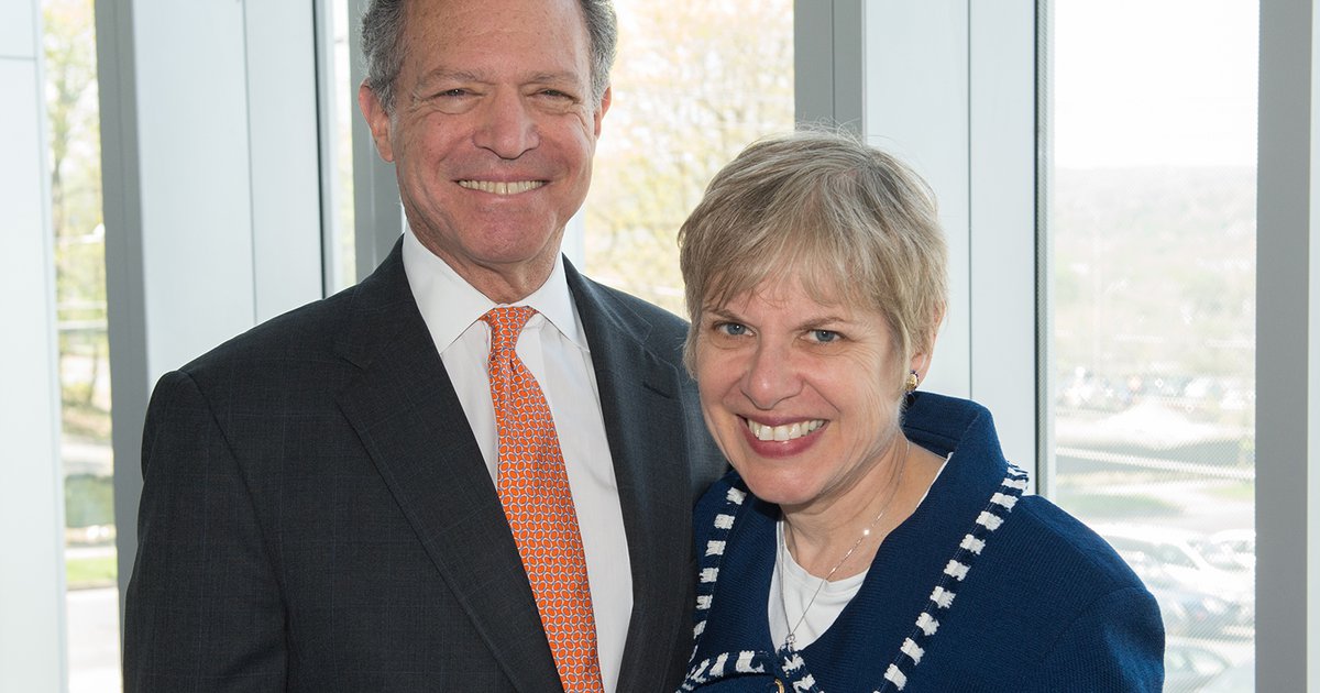 head and shoulders posed photo of couple in professional attire