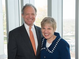 William J. ('65, G'68) and Joan ('67, G'68) Brodsky smiling in front of a window